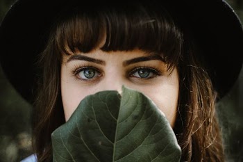 women beside green leaf
