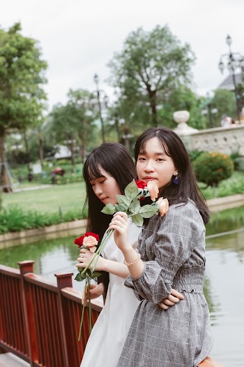 Women Holding Flowers