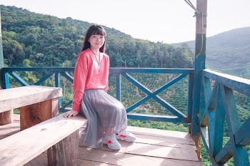 Women in Pink Sweater Sitting on Bench