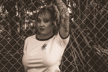 Women in White T-shirt Standing Near Fence