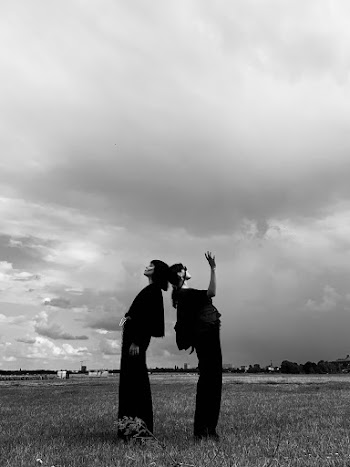Women Leaning on Each Other