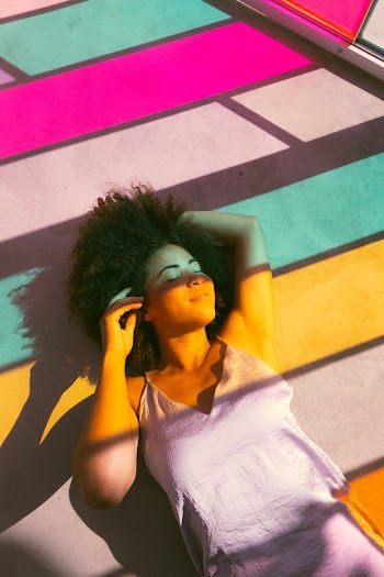 Women Lying Near to a Multicolored Glass Window Close-up Photography