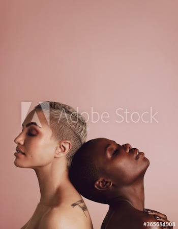 Women of different ethnicity standing back to back