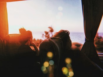Women Seated in a Bus Looking Outside