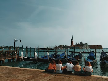Women Sitting Beside Calm Body of Water