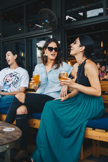 Women Sitting on Bench Restaurant