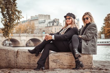 Women Sitting on Brown Rock