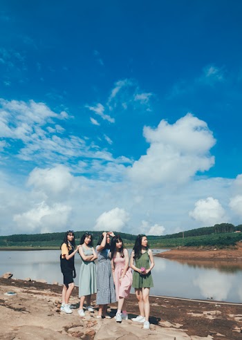 Women Standing Near Body Of Water