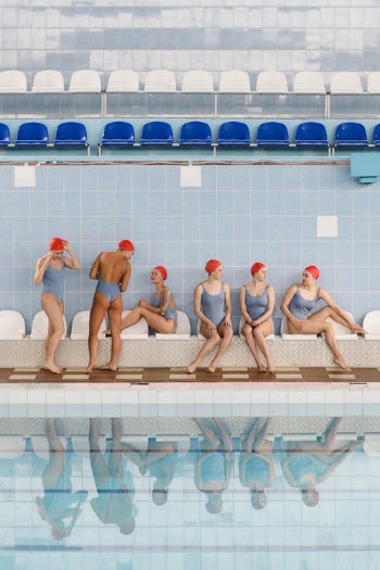 Women Synchronize Swimming Team Sitting by the Poolside · Free Stock Photo