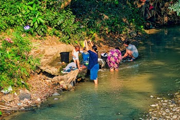 Women Washing Clothes by the River