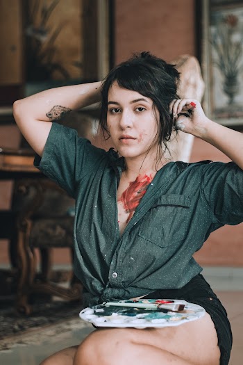 Women wearing a green button-up shirt