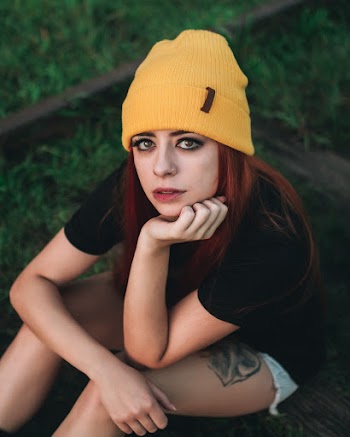 Women wearing black t-shirt and yellow knit cap