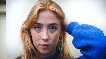 Women Wearing Blue Sweater Touching Her Hair