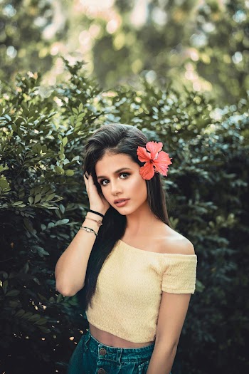Women With Pink Flower and Green Leaves Background