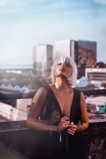 Women With Platinum Blonde Hair In A Black Sleeveless Dress 