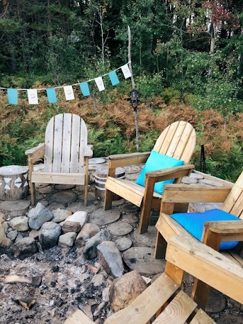 Wooden Armchairs In Front of a Campfire