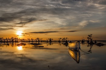 Wooden Boat on Water Under Golden Sky