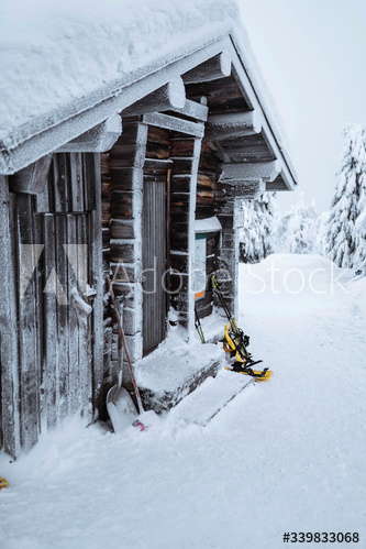 Wooden cabin in a snowy forest in Finland