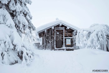 Wooden cabin in a snowy forest in Finland