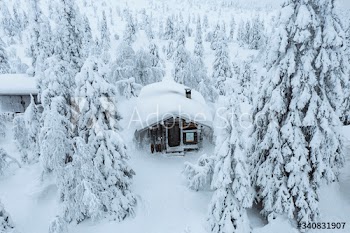 Wooden cabin in a snowy forest in Finland