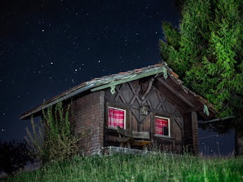 Wooden Cabin Near Trees at Night