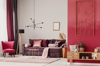 Wooden cupboard and red armchair in cozy living room interior with mockup of empty poster