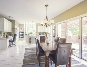 Wooden Dining Table On Area Rug