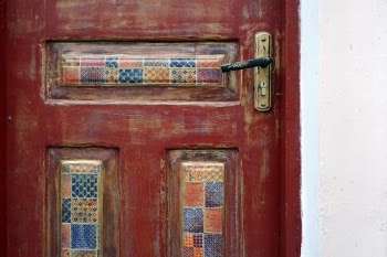Wooden door, decorated with patterns.