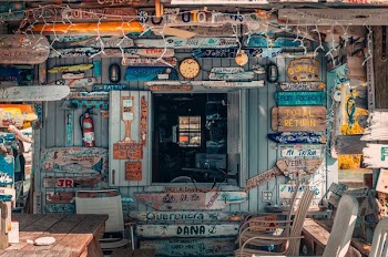 wooden house with assorted signage