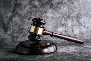 Wooden judges gavel on table in a courtroom or enforcement office. Free Photo