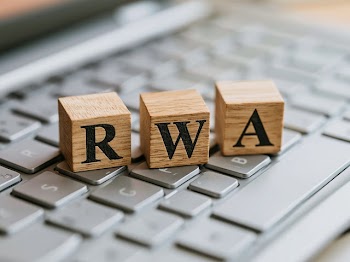 Wooden Letter Blocks 'RWA' on Silver Laptop Keyboard