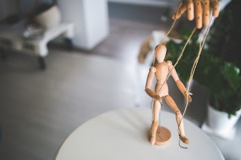 Wooden mannequin as a marionette