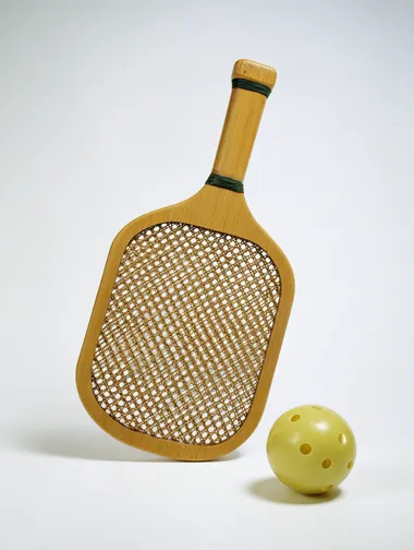 Wooden Pickleball Racket and Ball on White Background Wooden Pickleball Racket and Ball on White Background