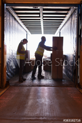 Workers loading boxes into truck