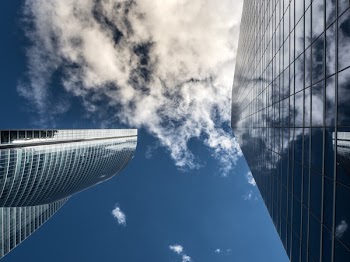 Worm's Eye View of High Rise Building Under White Cloudy Sky