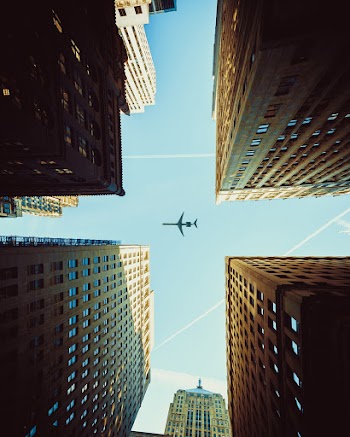 Worm's Eye View Photography Of Airplane And Buildings