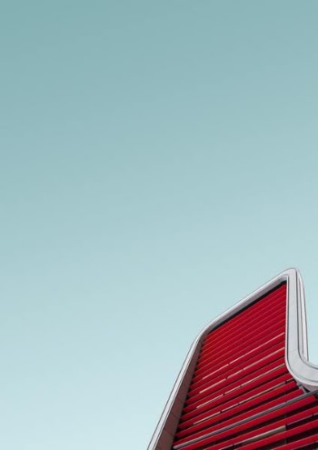 worm's eye view of red and silver building during daytime