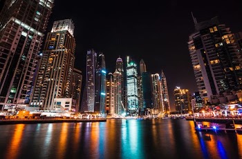 worm's eye view photography of city buildings at night