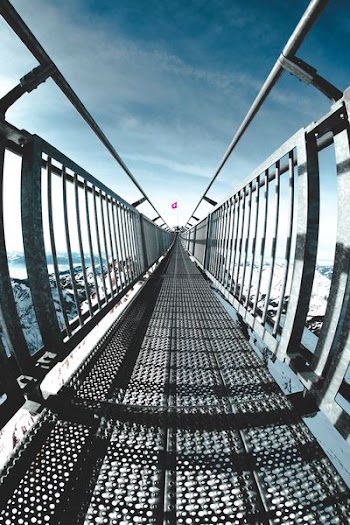 worm's eye view photography of metal bridge