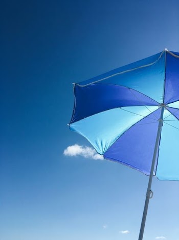 worms-eye-view of blue patio umbrella