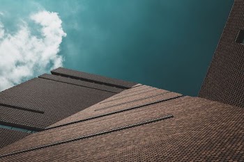 worms eye view of brown concrete building during day time