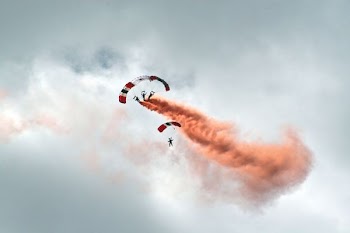 worms eye view photography of people paragliding under cloudy sky