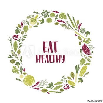 Wreath made of green plants, salad leaves, vegetables, herbs and Eat Healthy slogan inside