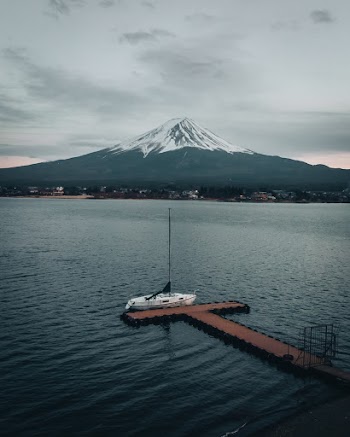 Yacht Beside Dock Near Mountain
