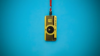 Yellow 212 Vip Camera Hanging on Blue Wall