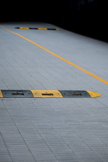 Yellow and Black Plastic Humps on Gray Concrete Floor