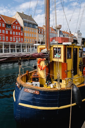 Yellow and Blue Boat Floating in a Canal