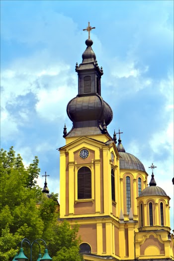 Yellow and Brown Concrete Church Near Green Tree