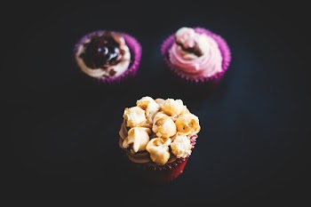 Yellow and Brown Cupcake Near Purple and White Cupcake