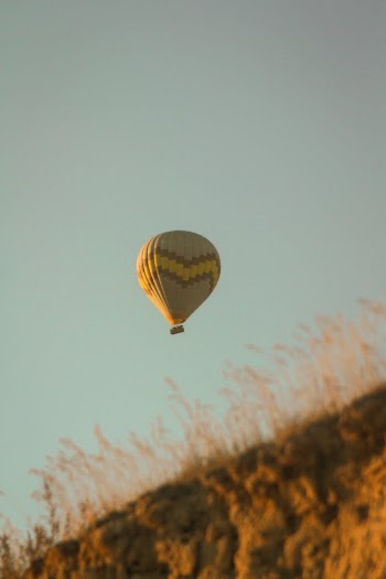 Yellow and Brown Hot Air Balloon in the Sky